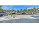 Waterfront backyard featuring boat dock, boat lift and fire pit at 619 Buttonwood Dr, Longboat Key, FL 34228