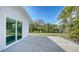 Well-maintained backyard with lush green lawn and mature palm trees, accessible via sliding glass doors at 619 Buttonwood Dr, Longboat Key, FL 34228