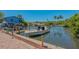 Waterfront property featuring boat dock, canal access, and nearby tropical landscaping at 619 Buttonwood Dr, Longboat Key, FL 34228