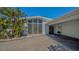 Modern home featuring geometric windows, an attached garage, and an expansive driveway at 619 Buttonwood Dr, Longboat Key, FL 34228