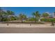 Serene landscaping with a palm-lined entrance creates a welcoming ambiance for this contemporary home at 619 Buttonwood Dr, Longboat Key, FL 34228