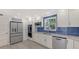 Beautiful kitchen with stainless steel appliances, blue backsplash, and granite countertops at 619 Buttonwood Dr, Longboat Key, FL 34228