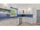 A well-appointed kitchen features white cabinets, stainless steel appliances, and a modern design at 619 Buttonwood Dr, Longboat Key, FL 34228