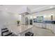 Spacious kitchen with a waterfall island, stainless steel appliances, and modern lighting at 619 Buttonwood Dr, Longboat Key, FL 34228