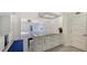 The modern kitchen is spacious and open and features barstool seating at the kitchen island at 619 Buttonwood Dr, Longboat Key, FL 34228