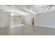 Spacious, bright open-concept living room featuring modern flooring and transom window at 619 Buttonwood Dr, Longboat Key, FL 34228