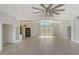 Open-concept living room with vaulted ceiling, modern floors, front door and transom window at 619 Buttonwood Dr, Longboat Key, FL 34228