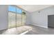 Bright living room with glass block window, wood floors and transom window at 619 Buttonwood Dr, Longboat Key, FL 34228