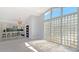 Bright living room with glass block window, wood floors and eat in kitchen at 619 Buttonwood Dr, Longboat Key, FL 34228