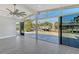 Open living room with modern flooring and sliding glass doors to backyard at 619 Buttonwood Dr, Longboat Key, FL 34228