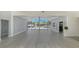 Large living room with modern flooring and sliding glass doors to backyard at 619 Buttonwood Dr, Longboat Key, FL 34228
