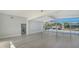 Open living room with modern flooring and sliding glass doors to water at 619 Buttonwood Dr, Longboat Key, FL 34228
