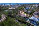Coastal home with canal access, boat dock, lush trees, and pool; nestled in a vibrant community at 650 Penfield St, Longboat Key, FL 34228