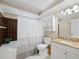 Cozy bathroom featuring a vanity with granite counters, shower with a tub, and a toilet at 650 Penfield St, Longboat Key, FL 34228