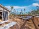 Inviting deck with lounge chairs, comfortable seating, and views of blue skies and lush greenery at 650 Penfield St, Longboat Key, FL 34228