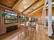 Bright dining area featuring wood floors, vaulted ceilings, and large windows at 650 Penfield St, Longboat Key, FL 34228