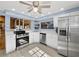 Charming kitchen featuring stainless steel appliances, white cabinetry, a sink, and ample natural light at 650 Penfield St, Longboat Key, FL 34228