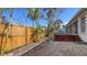 Gravel backyard featuring a fenced yard, tropical foliage, and a deck area for relaxing at 710 Birdsong Ln, Sarasota, FL 34242