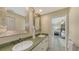 A full bathroom offers double sinks, lots of natural light, and decorative accents at 710 Birdsong Ln, Sarasota, FL 34242