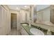 Spacious bathroom with a double sink vanity, ample storage space, and large mirrors at 710 Birdsong Ln, Sarasota, FL 34242