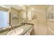 Bathroom vanity with granite countertops, a decorative mirror, and seaside decor at 710 Birdsong Ln, Sarasota, FL 34242