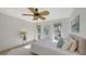 This bright and airy bedroom features a decorative fan and sun-filled windows at 710 Birdsong Ln, Sarasota, FL 34242