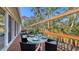 Outdoor deck with dining and lounge area, overlooking tropical landscaped yard at 710 Birdsong Ln, Sarasota, FL 34242
