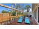 Outdoor deck with lounge chairs, overlooking tropical landscaped yard at 710 Birdsong Ln, Sarasota, FL 34242