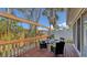 Outdoor deck with a dining set surrounded by lush greenery, perfect for enjoying meals outside at 710 Birdsong Ln, Sarasota, FL 34242