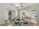 Dining area adjacent to living space, features a glass table and chairs with views into the house at 710 Birdsong Ln, Sarasota, FL 34242