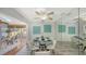 Elegant dining area with glass table, white chairs, stylish decor, and view into living area at 710 Birdsong Ln, Sarasota, FL 34242