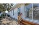 Exterior of the house with steps to a patio and sliding glass doors at 710 Birdsong Ln, Sarasota, FL 34242