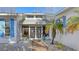 Close up of home entrance with tiled walkway, decorative doors, and blue shutters at 710 Birdsong Ln, Sarasota, FL 34242