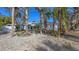 Charming single-Gathering home featuring mature landscaping, a large garage, and blue shutters at 710 Birdsong Ln, Sarasota, FL 34242