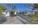 Charming home featuring well-kept landscaping, a large garage, and blue shutters at 710 Birdsong Ln, Sarasota, FL 34242