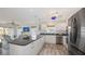 This bright kitchen features stainless steel appliances, granite countertops, and an eat-in breakfast bar at 710 Birdsong Ln, Sarasota, FL 34242