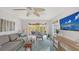 Bright living room with ceiling fan, comfortable seating, and access to a charming outdoor deck at 710 Birdsong Ln, Sarasota, FL 34242