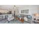 Open-concept living room and kitchen with counter seating, neutral colors, and ample natural light at 710 Birdsong Ln, Sarasota, FL 34242