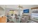 Comfortable living room with ceiling fan, large windows, and access to the deck at 710 Birdsong Ln, Sarasota, FL 34242