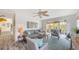 Cozy living area with stylish decor, comfortable sofa, area rug, and sliding glass doors to outdoor space at 710 Birdsong Ln, Sarasota, FL 34242