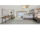 An open and bright main bedroom features a decorative fan, large window and an elegant area rug at 710 Birdsong Ln, Sarasota, FL 34242