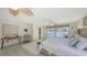 This airy main bedroom features a ceiling fan, desk, neutral colors, and outside access at 710 Birdsong Ln, Sarasota, FL 34242