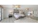 An airy main bedroom with an en suite bath and patio access to the outdoor space and pool at 710 Birdsong Ln, Sarasota, FL 34242
