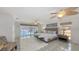This airy main bedroom features beautiful floors and a large patio door overlooking the pool at 710 Birdsong Ln, Sarasota, FL 34242