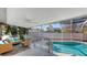 A screened-in pool area featuring outdoor furniture and a refreshing in-ground pool at 710 Birdsong Ln, Sarasota, FL 34242