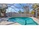 A private, in-ground pool is enclosed by a screened cage that protects from insects and debris at 710 Birdsong Ln, Sarasota, FL 34242