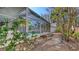 Screened-in pool area surrounded by tropical foliage and landscaping, for privacy at 710 Birdsong Ln, Sarasota, FL 34242