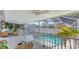 Screened-in pool area featuring outdoor furniture, ceiling fans, and a refreshing in-ground pool at 710 Birdsong Ln, Sarasota, FL 34242