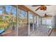 Florida sunroom featuring wood-look tile flooring and sliding glass doors to the outdoor deck at 710 Birdsong Ln, Sarasota, FL 34242