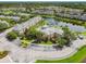 Beautiful aerial view of community with pool, lake, and lush landscaping at 7632 Plantation Cir, Bradenton, FL 34201